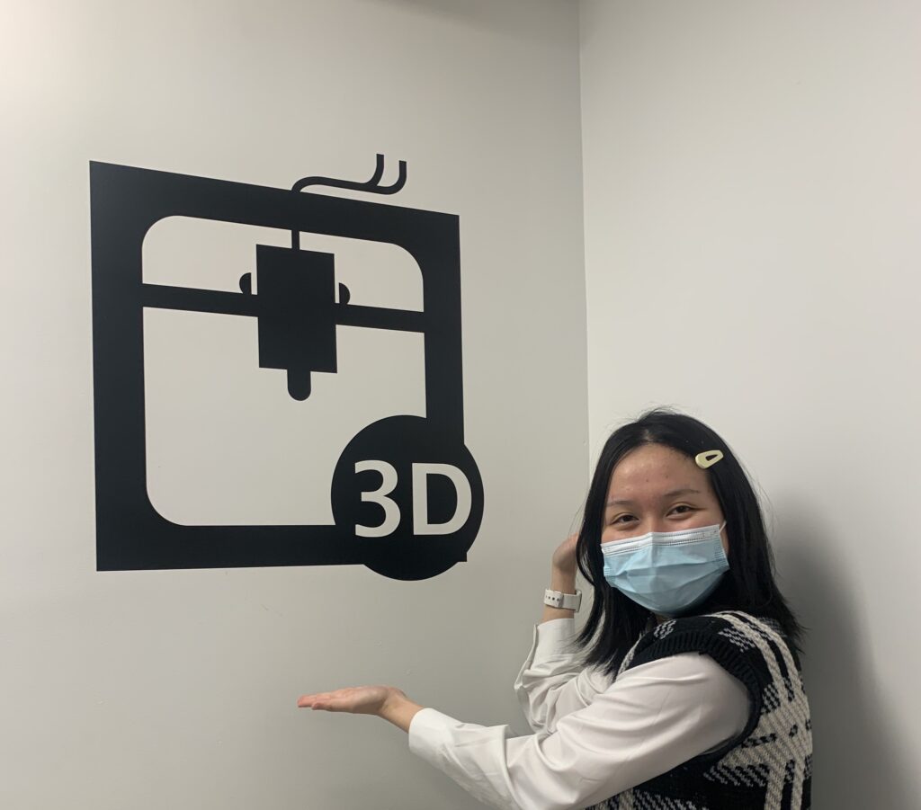 Student posing near sign that says 3D