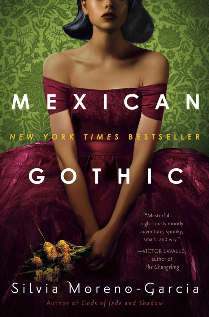 Book cover for Mexican Gothic by Silvia Moreno-Garcia. The cover features a Latina woman sitting in a large maroon coloured dress. The top of her head is out of frame. Her hands are crossed in her lap and she is holding a small bouquet of flowers. Behind her is green patterned wallpaper.