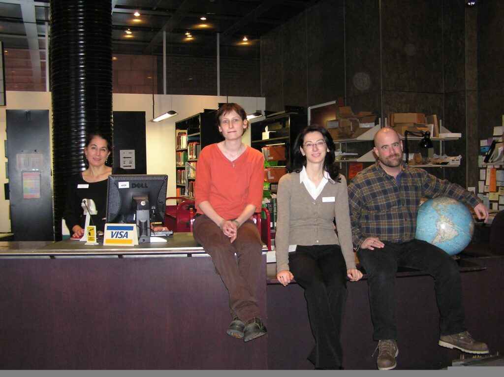 At the Gelber circulation desk, circa 2007.  From L to R: Anne Avery, Lisa Barrett, Mila Bozic Erkic, and Brock Cummings