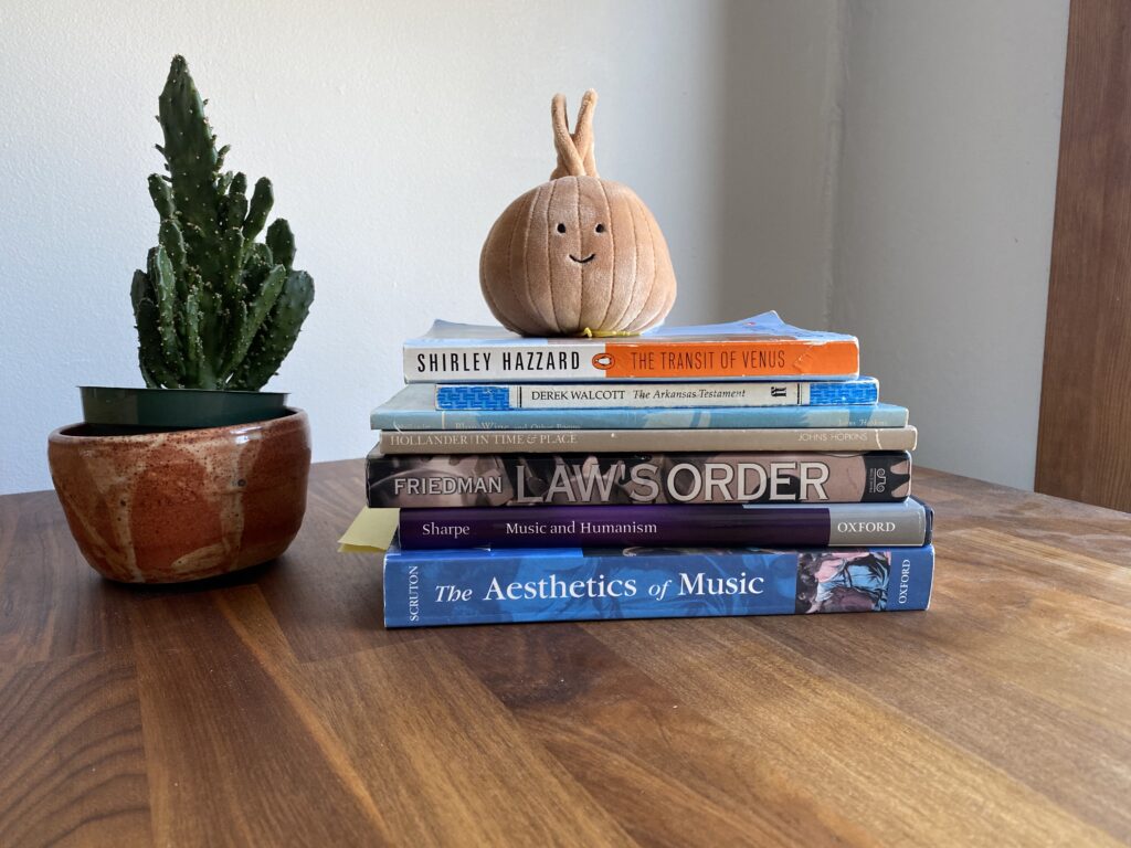 pile of books next to cactus